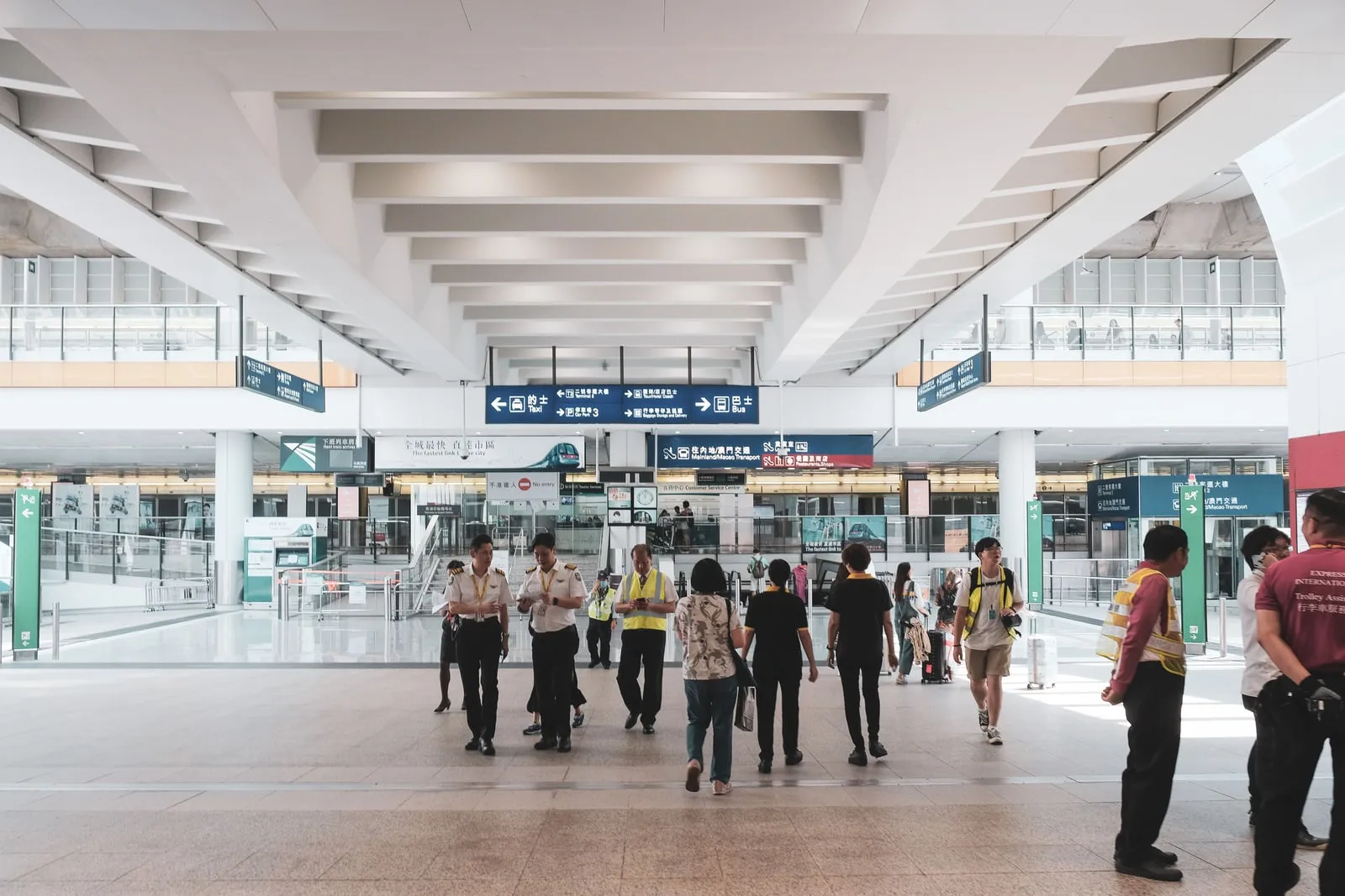 Travellers walking through a transit terminal concourse