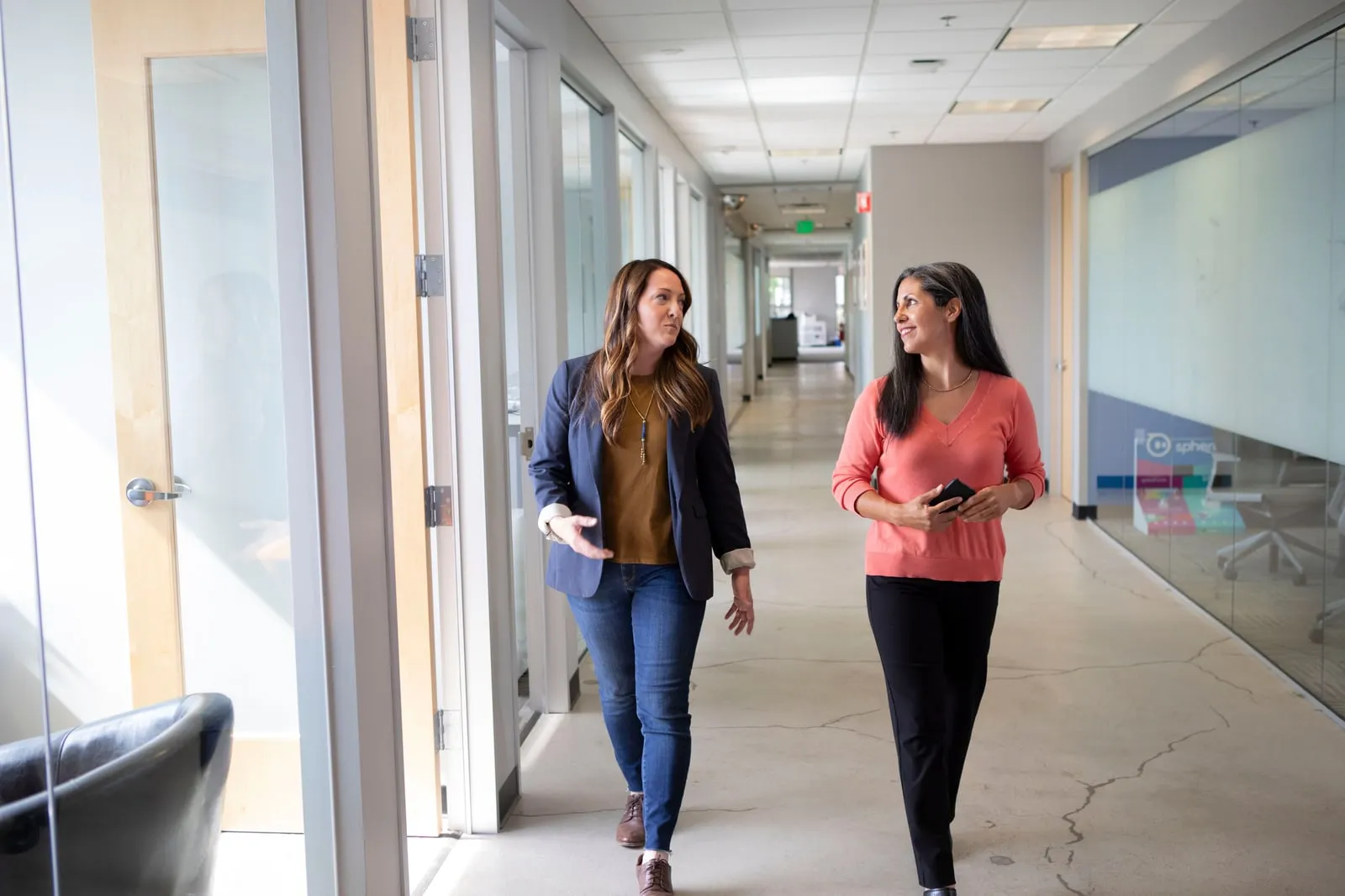 People walking through an office corridor
