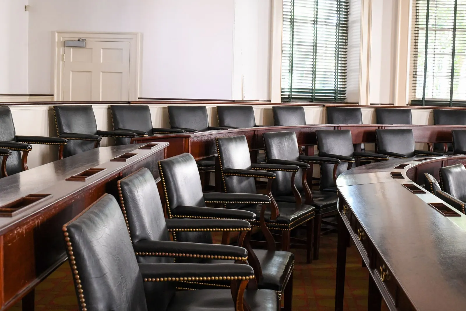 Empty leather chairs in a historic legislative chamber