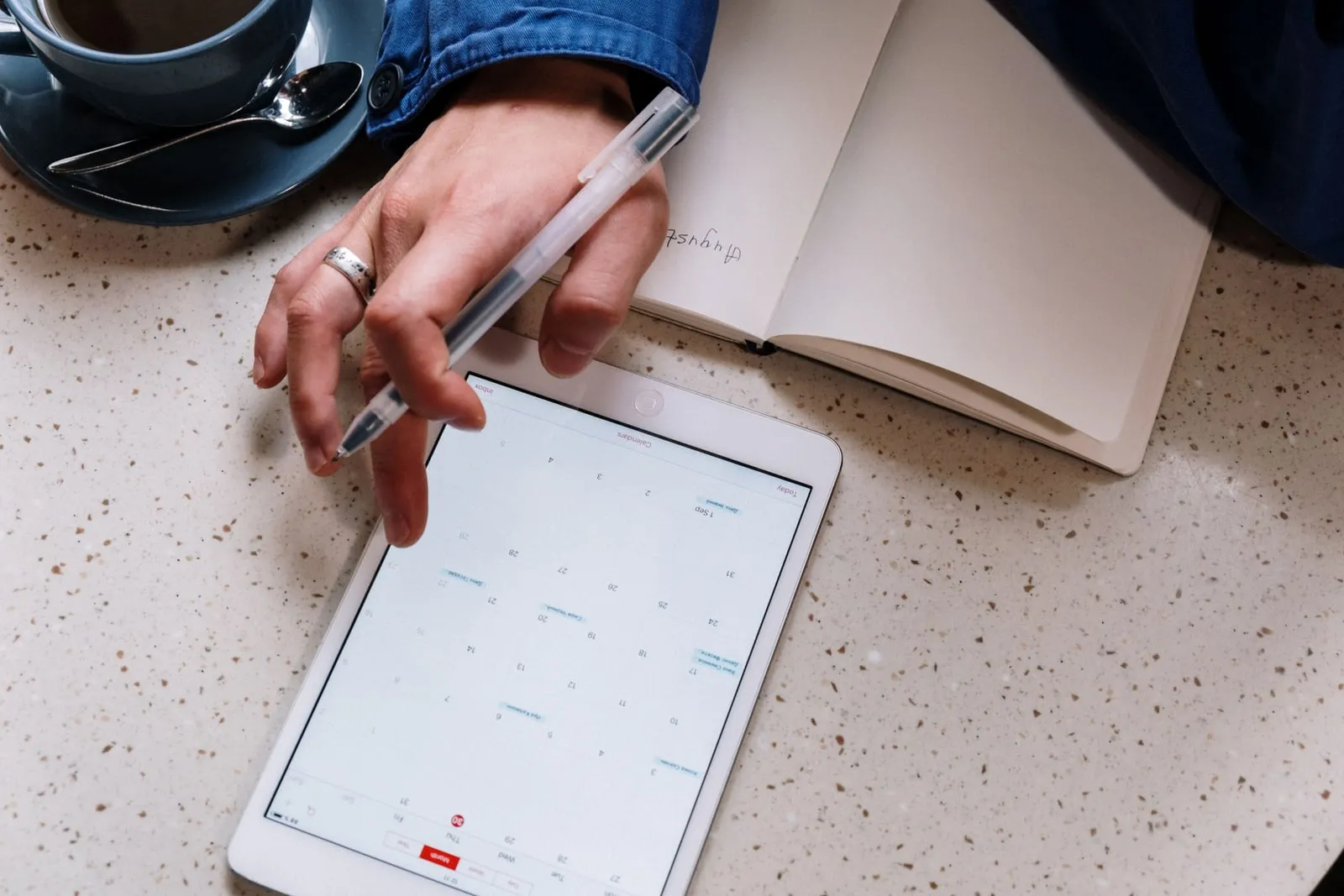A calendar application open on a tablet on a desk