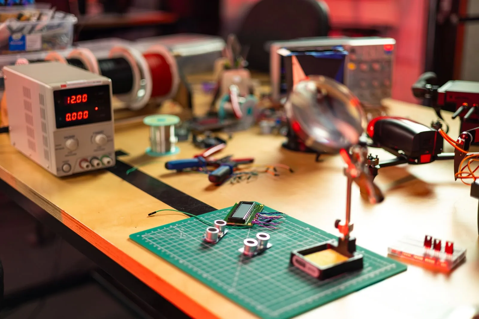 An electronics workbench with a bench power supply and soldering tools