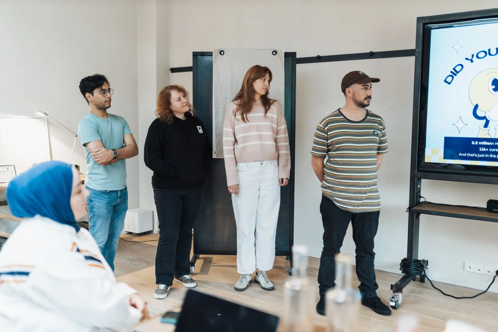 Colleagues reviewing presentation slides in a meeting room