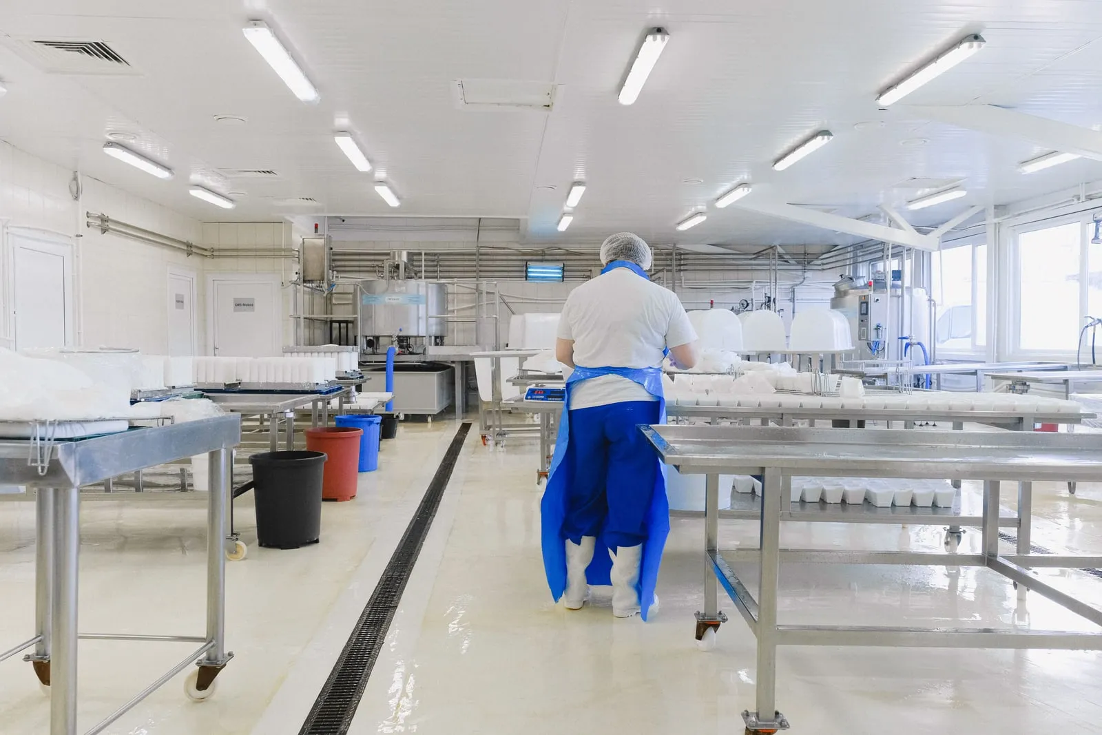 Workers in white cleanroom suits inside a semiconductor factory