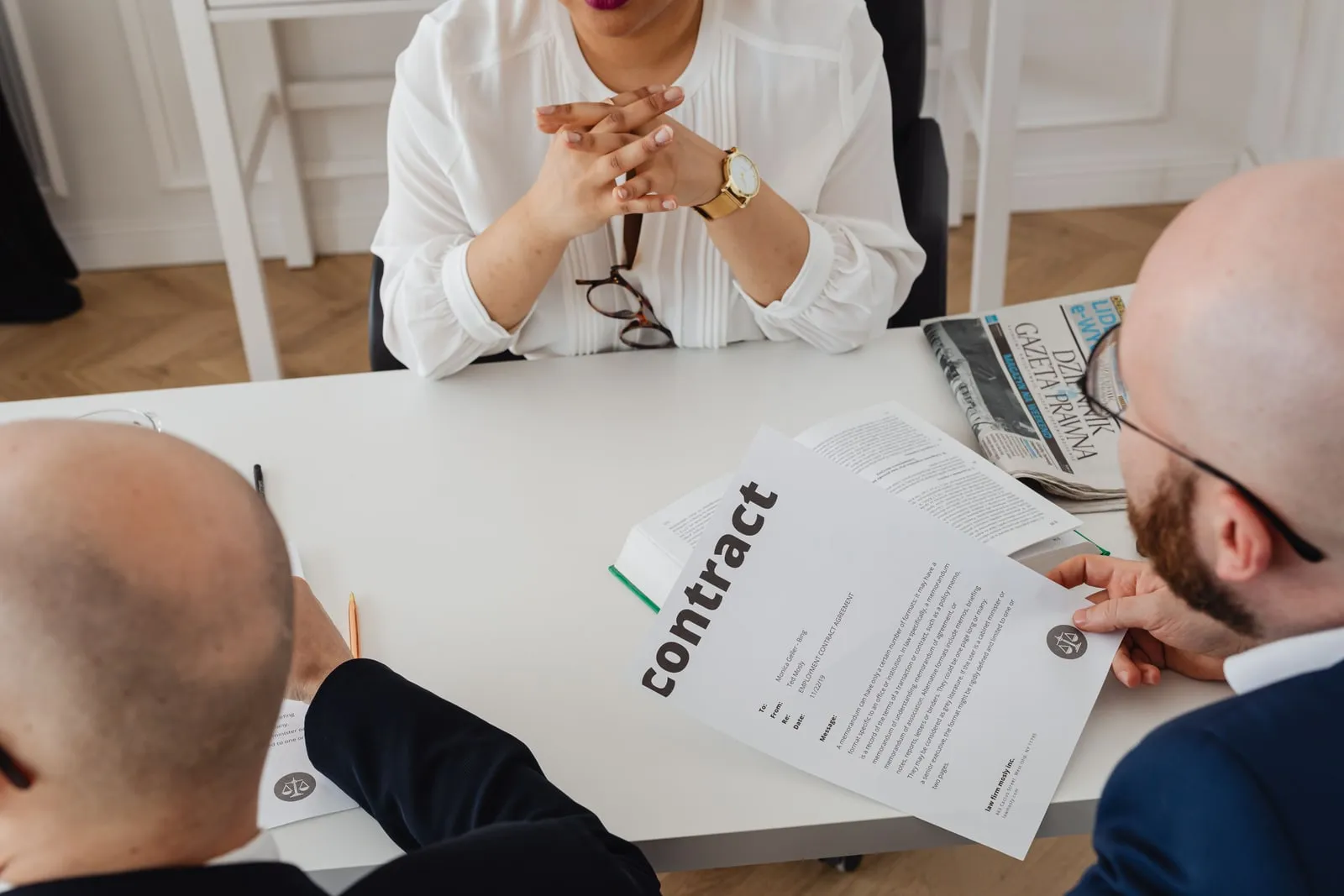 Lawyers reading documents around a conference table