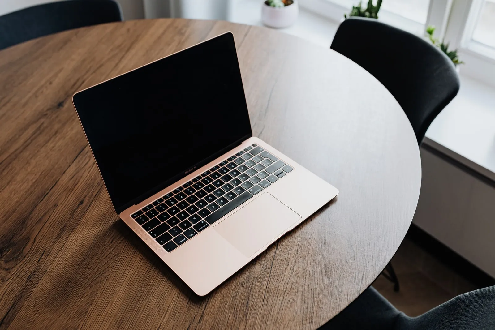 A laptop open on a table at a conference