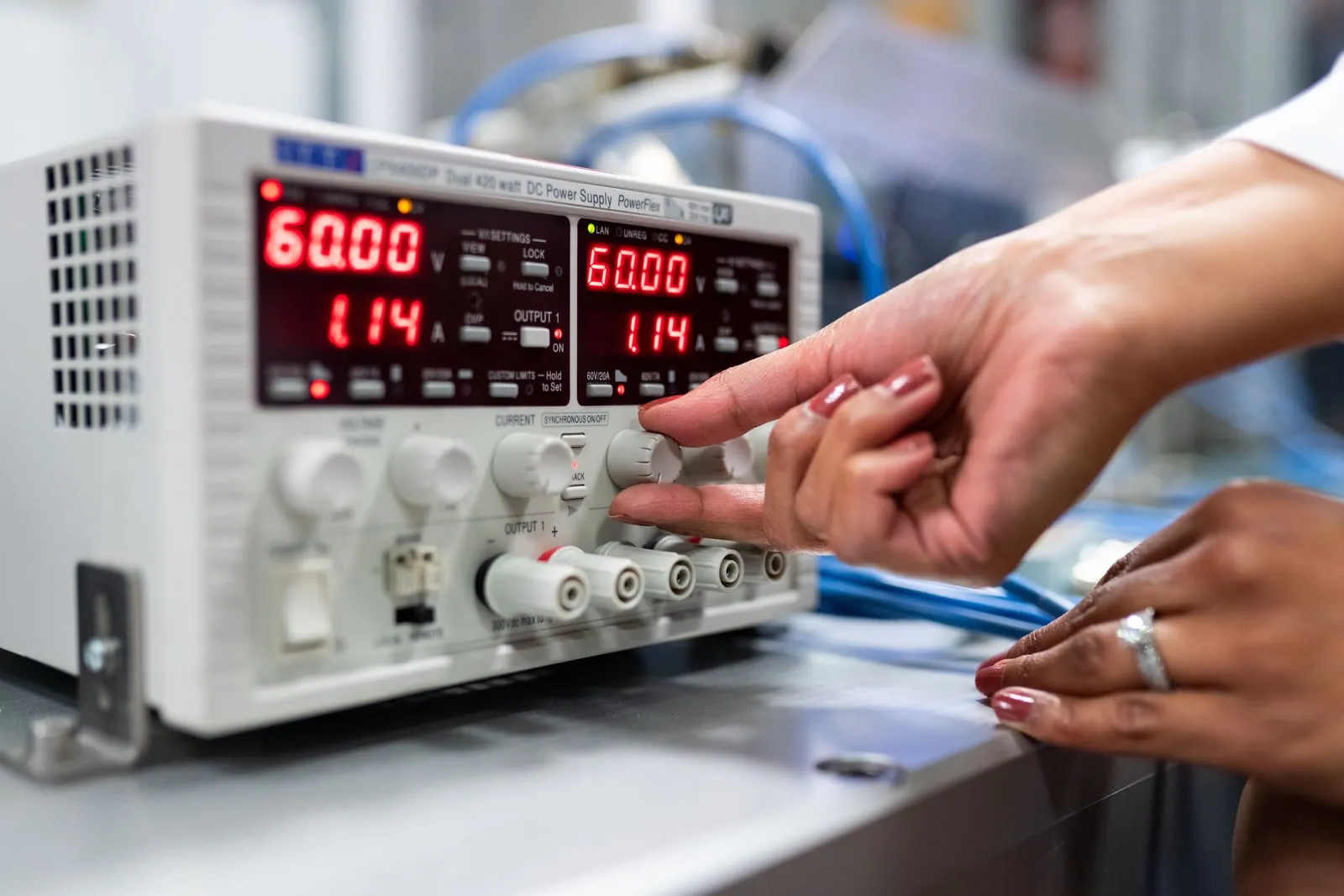 An engineer adjusting dials on laboratory equipment