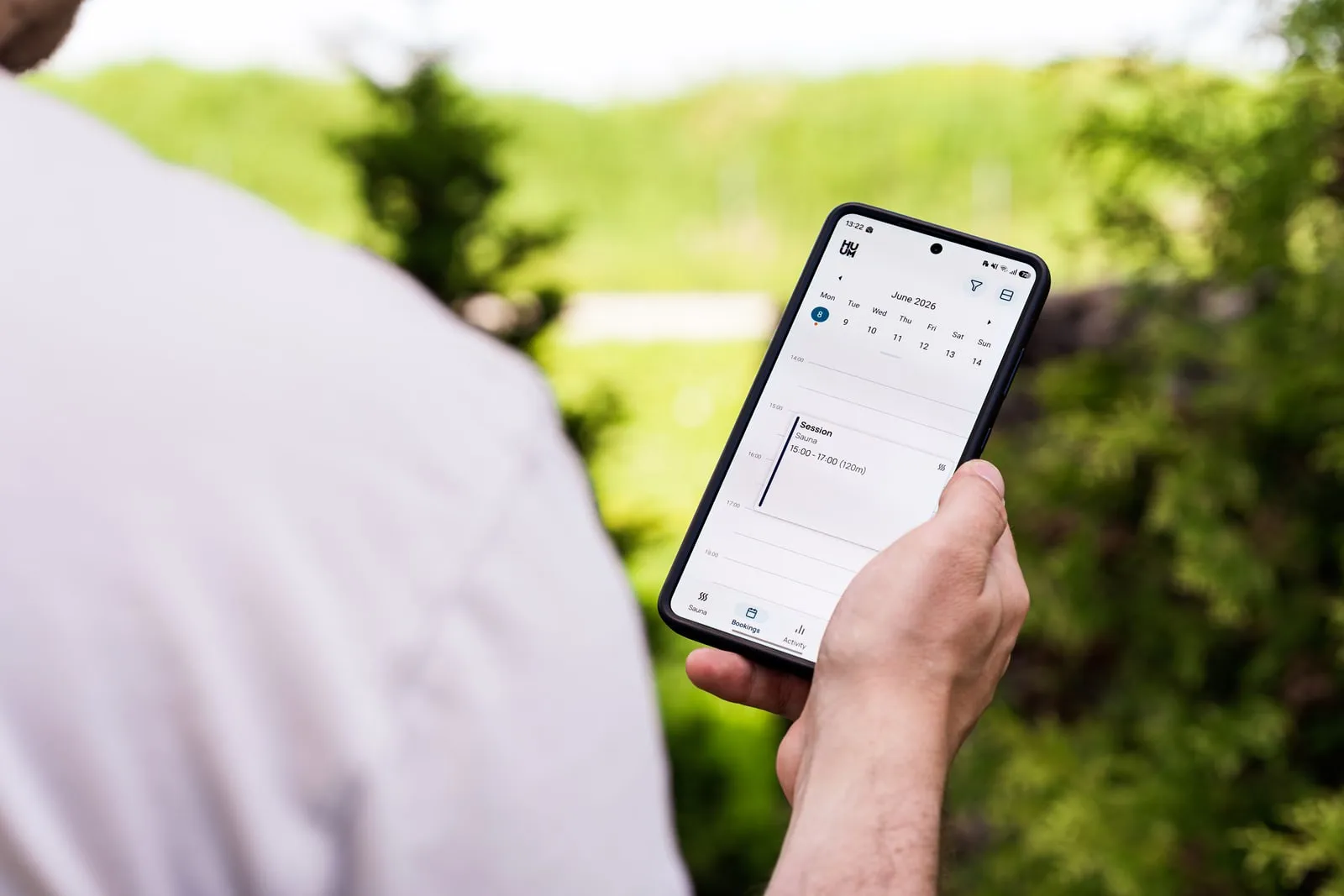 A person checking a calendar app on a smartphone outdoors