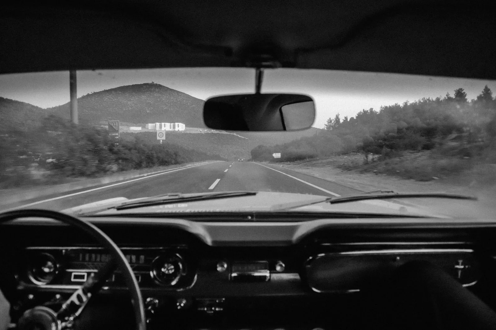 A view of an empty road from a camera mounted on a car dashboard