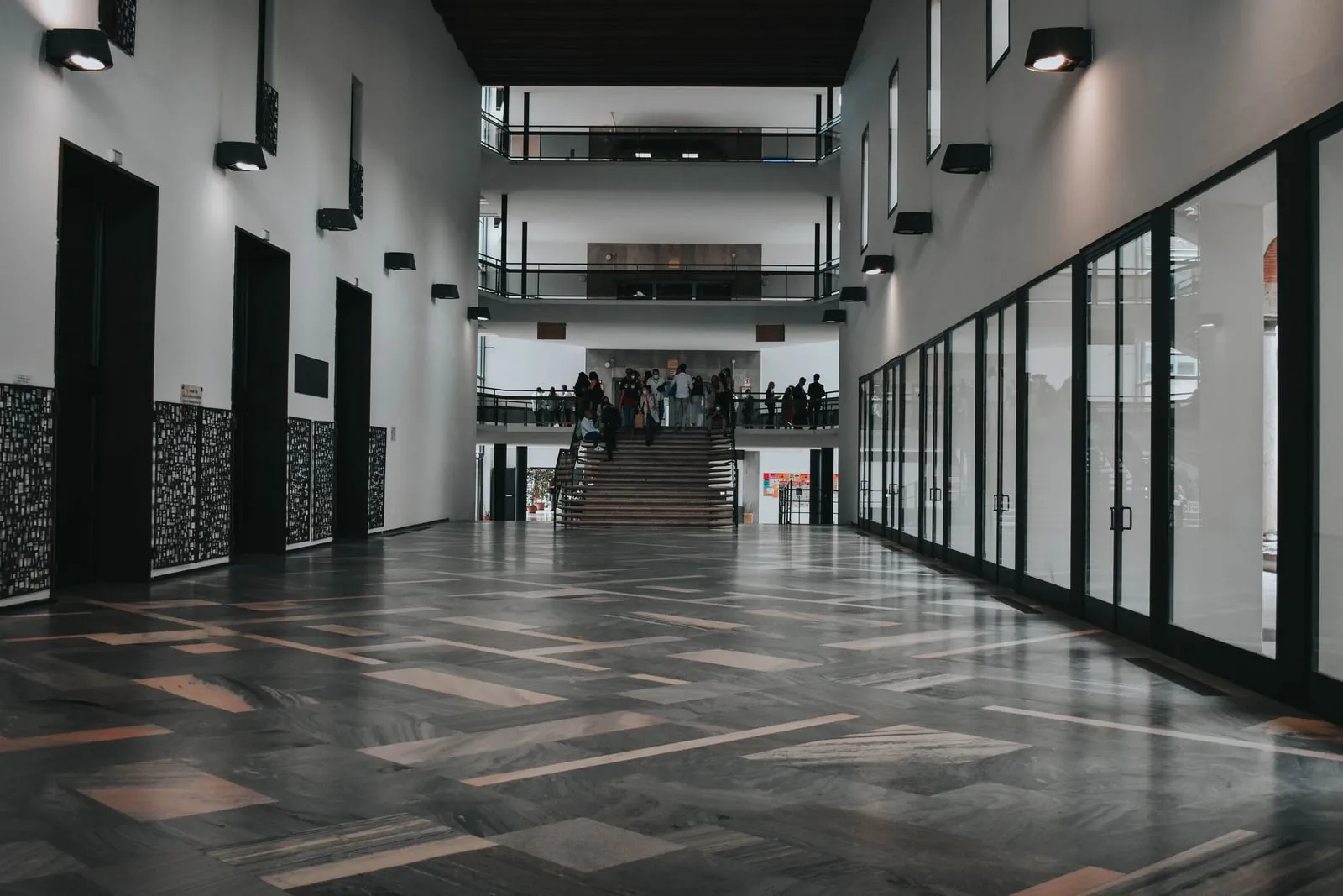 People walking through the lobby of a large office building