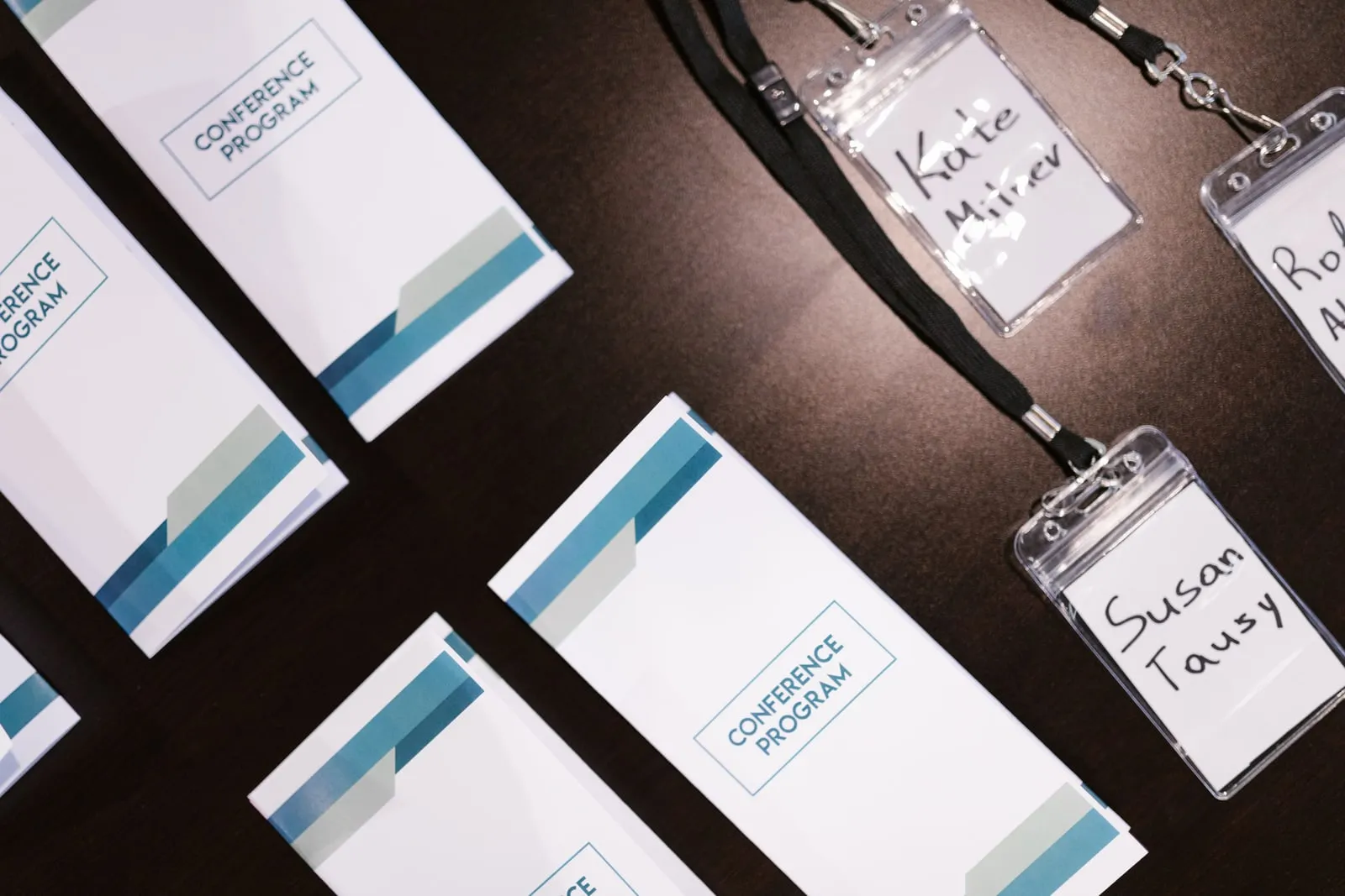 Conference programmes and name badges laid out on a table