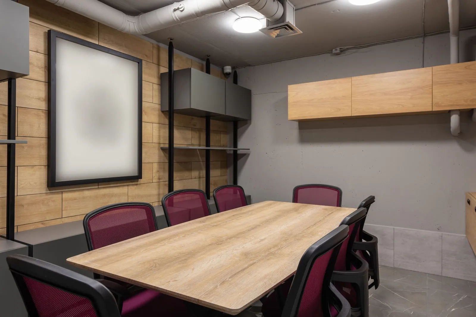 A town hall meeting room with rows of empty chairs