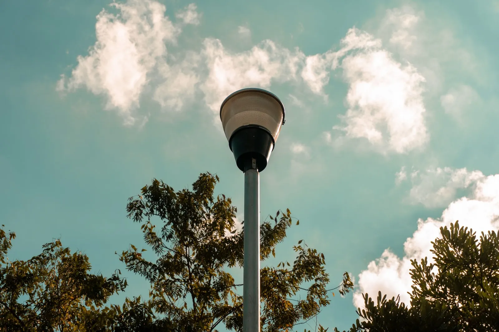 A street light on a pole against the sky