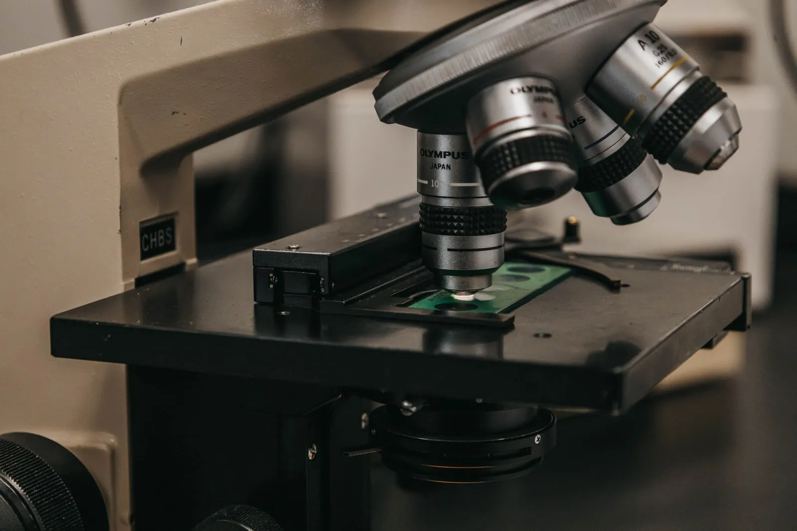 A researcher adjusting equipment on an optical table