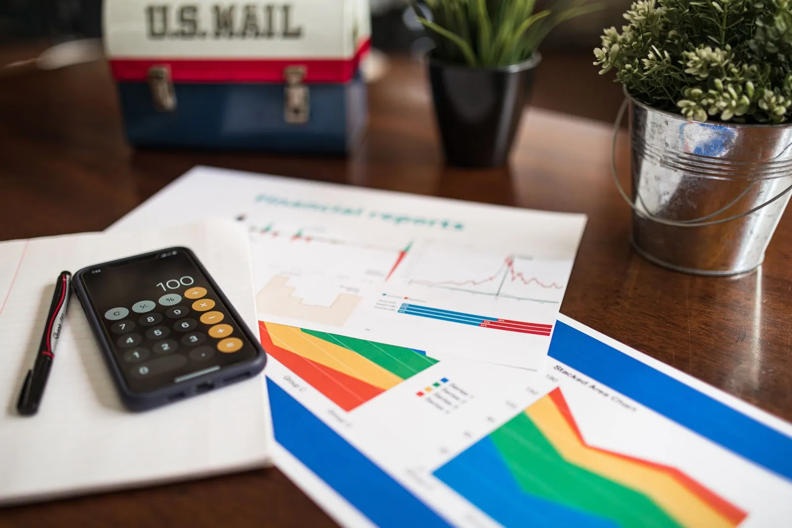 A calculator and financial papers on a desk