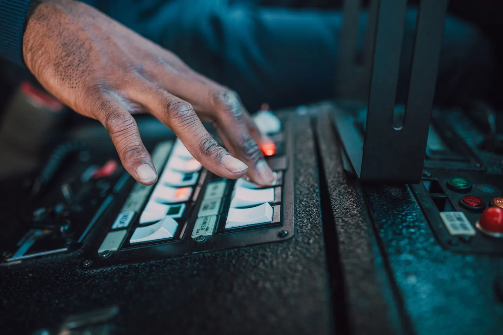 A hand pressing a button on a device