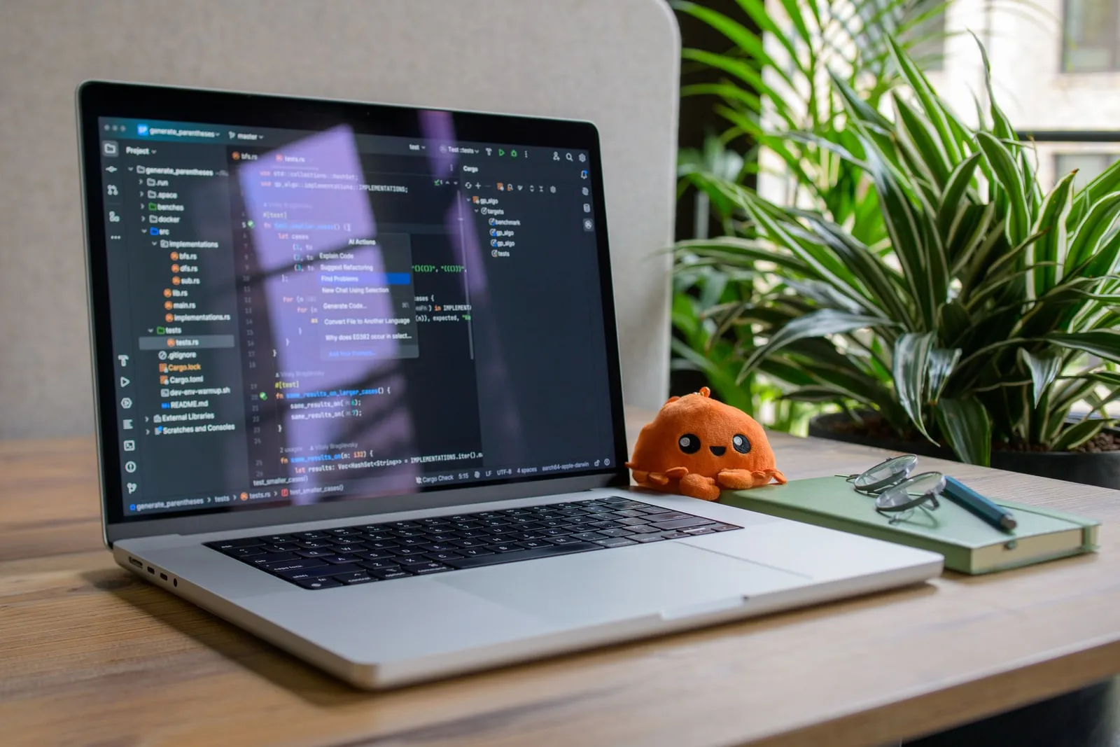A laptop open on a desk with code on the screen