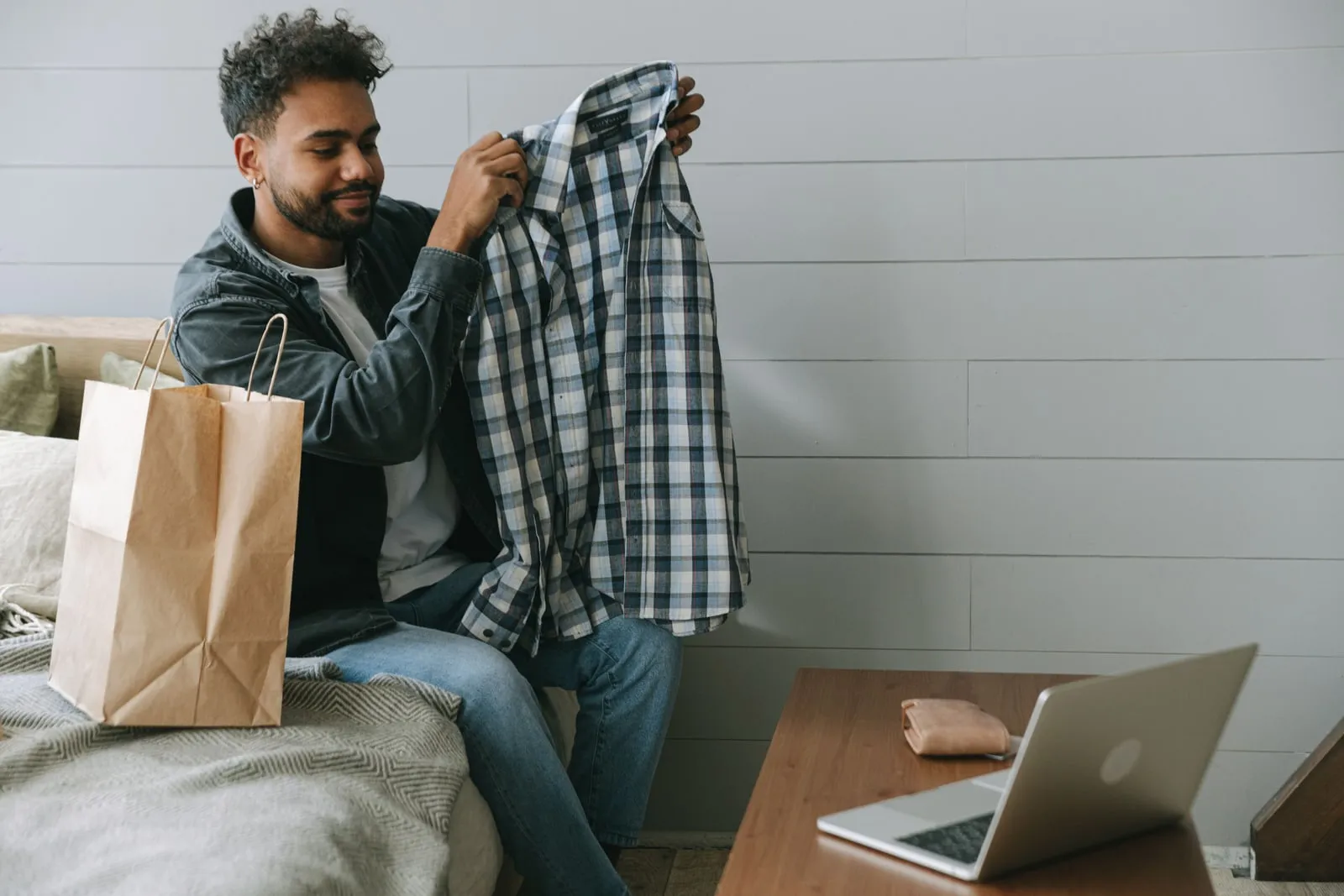 A person shopping online on a laptop at home