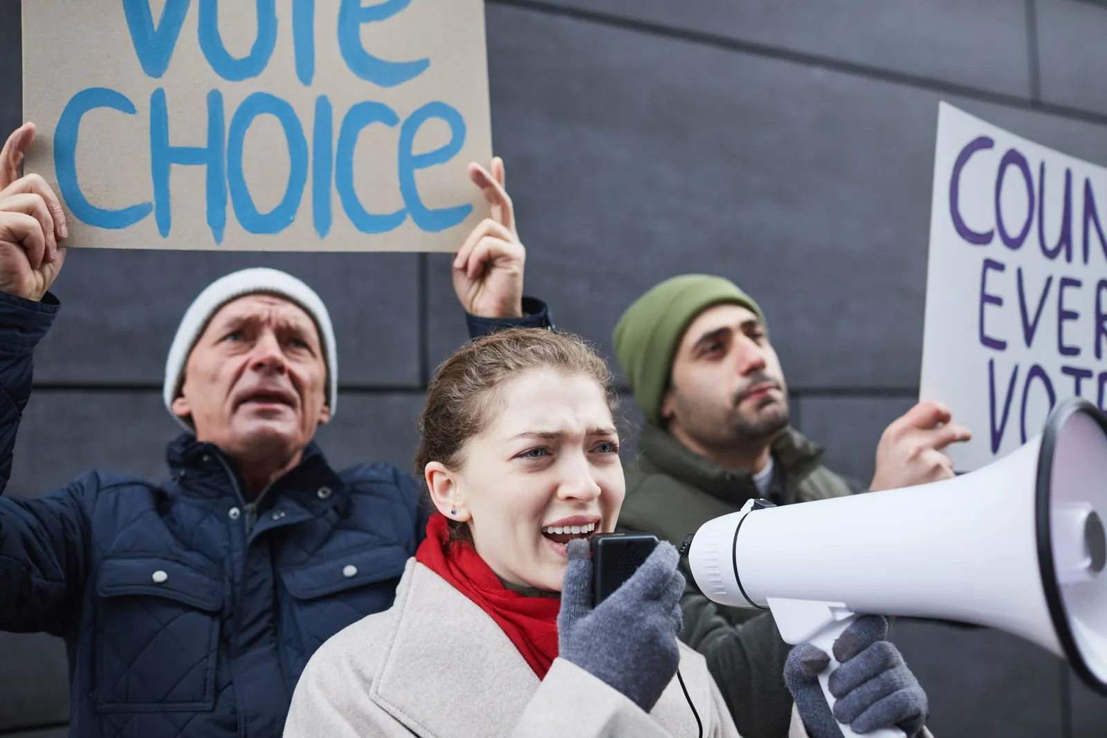 People at a public demonstration holding placards