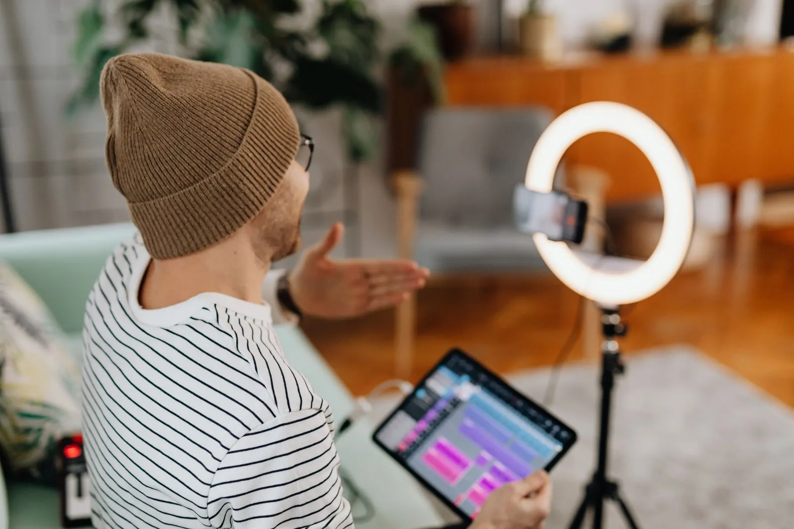 A person speaking to a camera under studio lighting