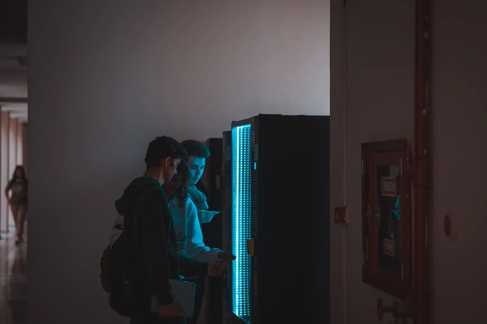 People using a vending machine in a corridor