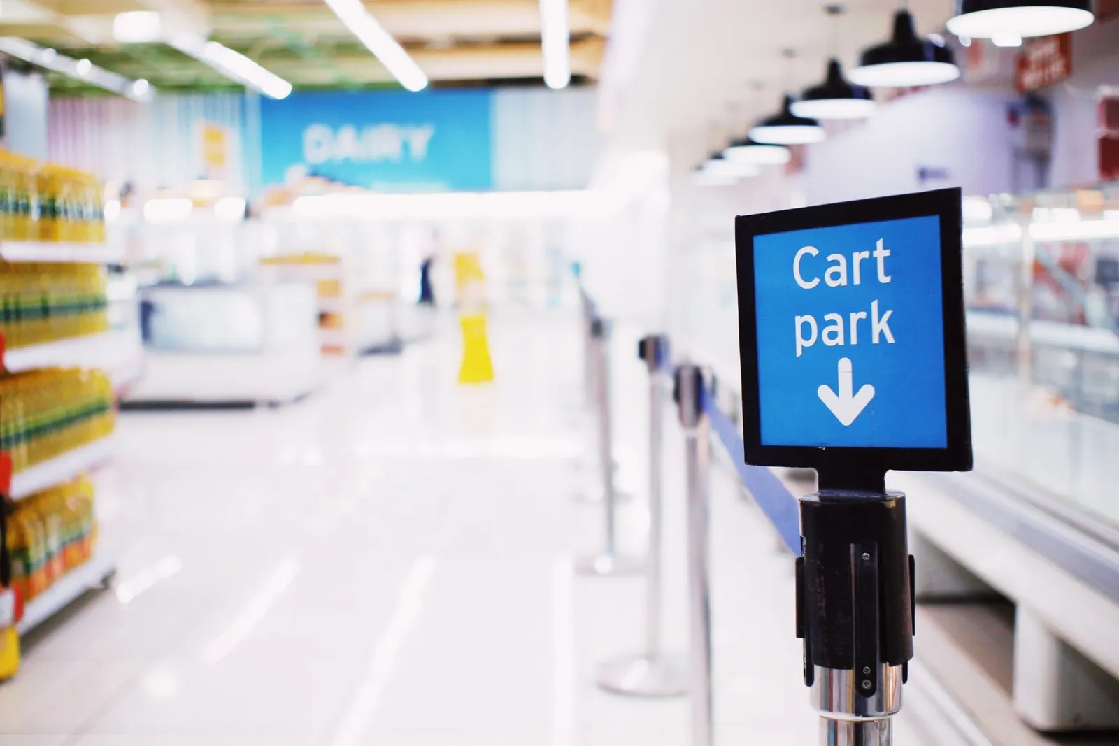 A shopping trolley in an empty supermarket aisle