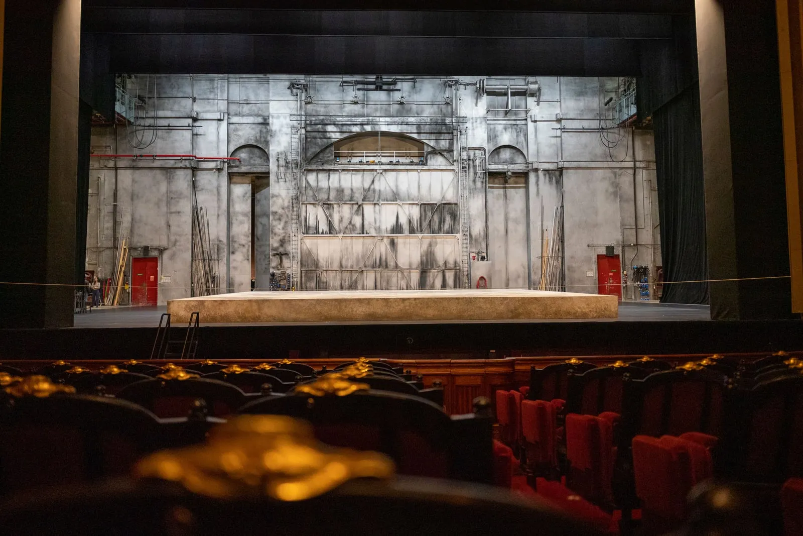 An empty theatre stage seen from the seats