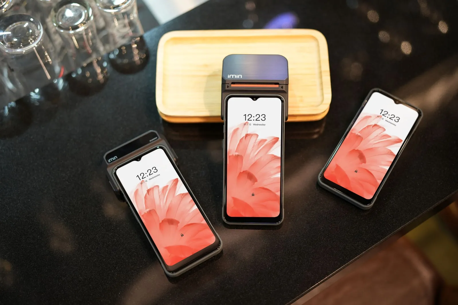 Several smartphones on a table showing their home screens