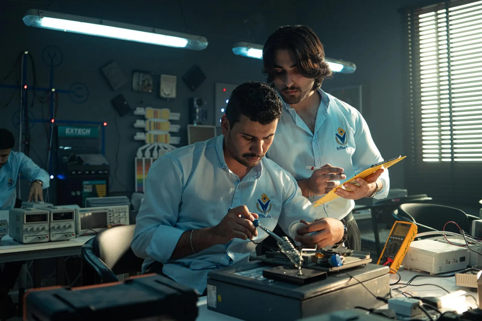 Engineers working at benches in an electronics research laboratory