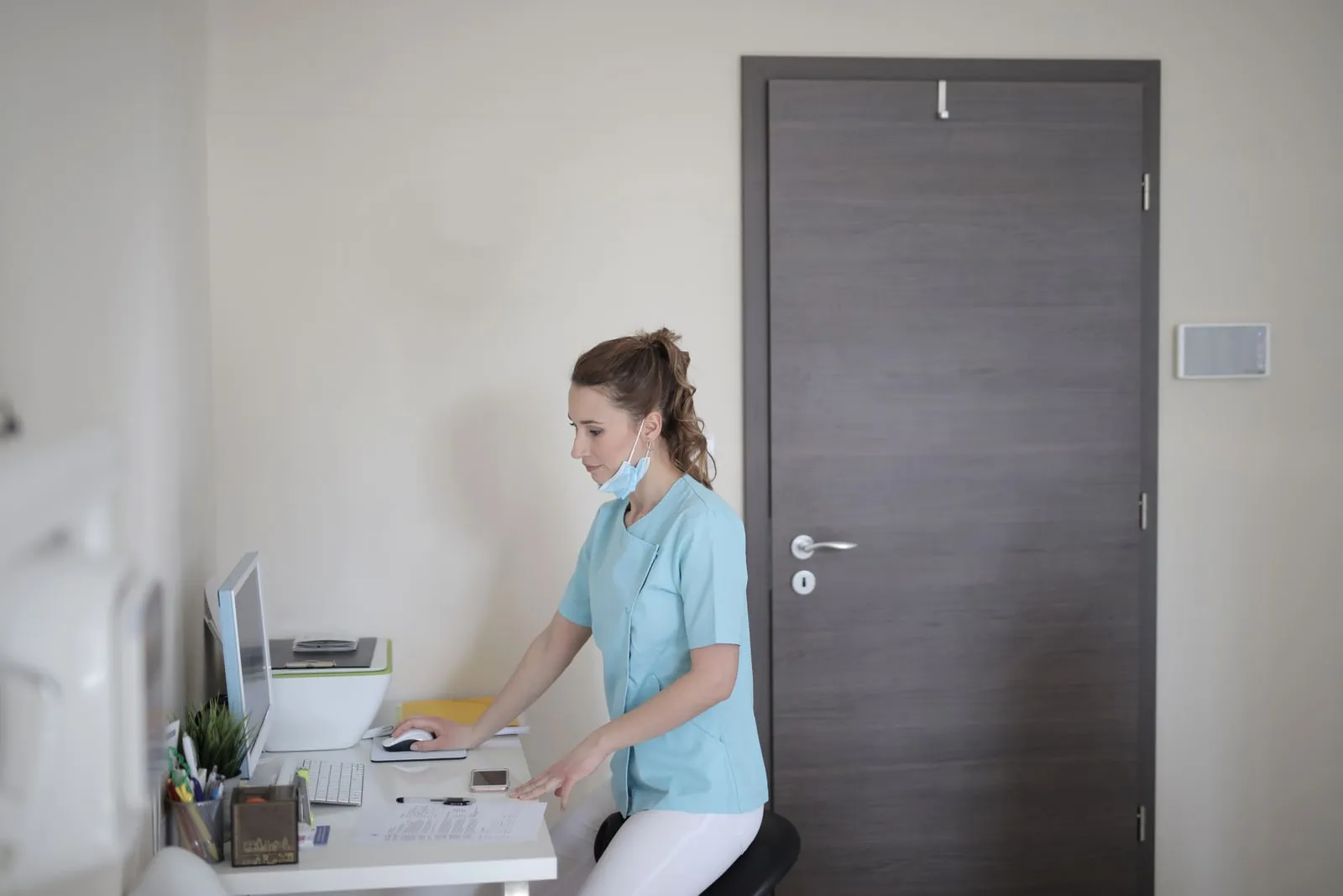 A clinician reviewing patient records on a computer screen