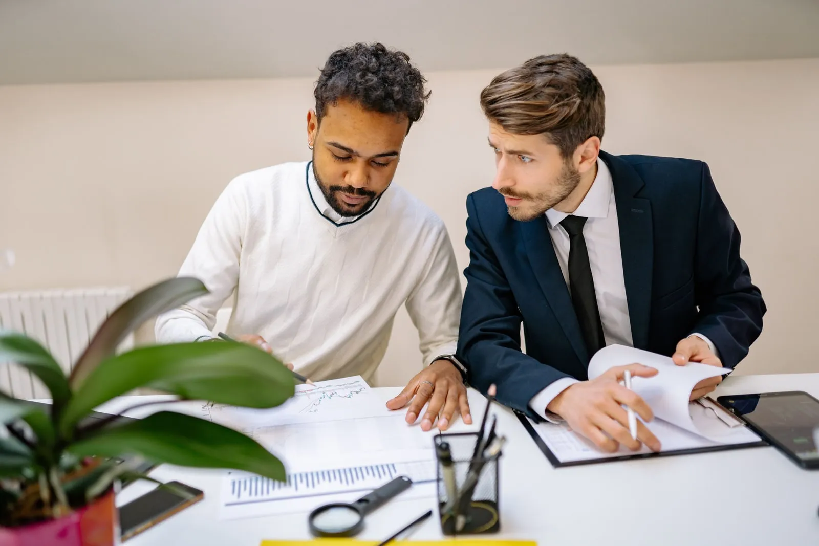 Two people reviewing a document at a desk