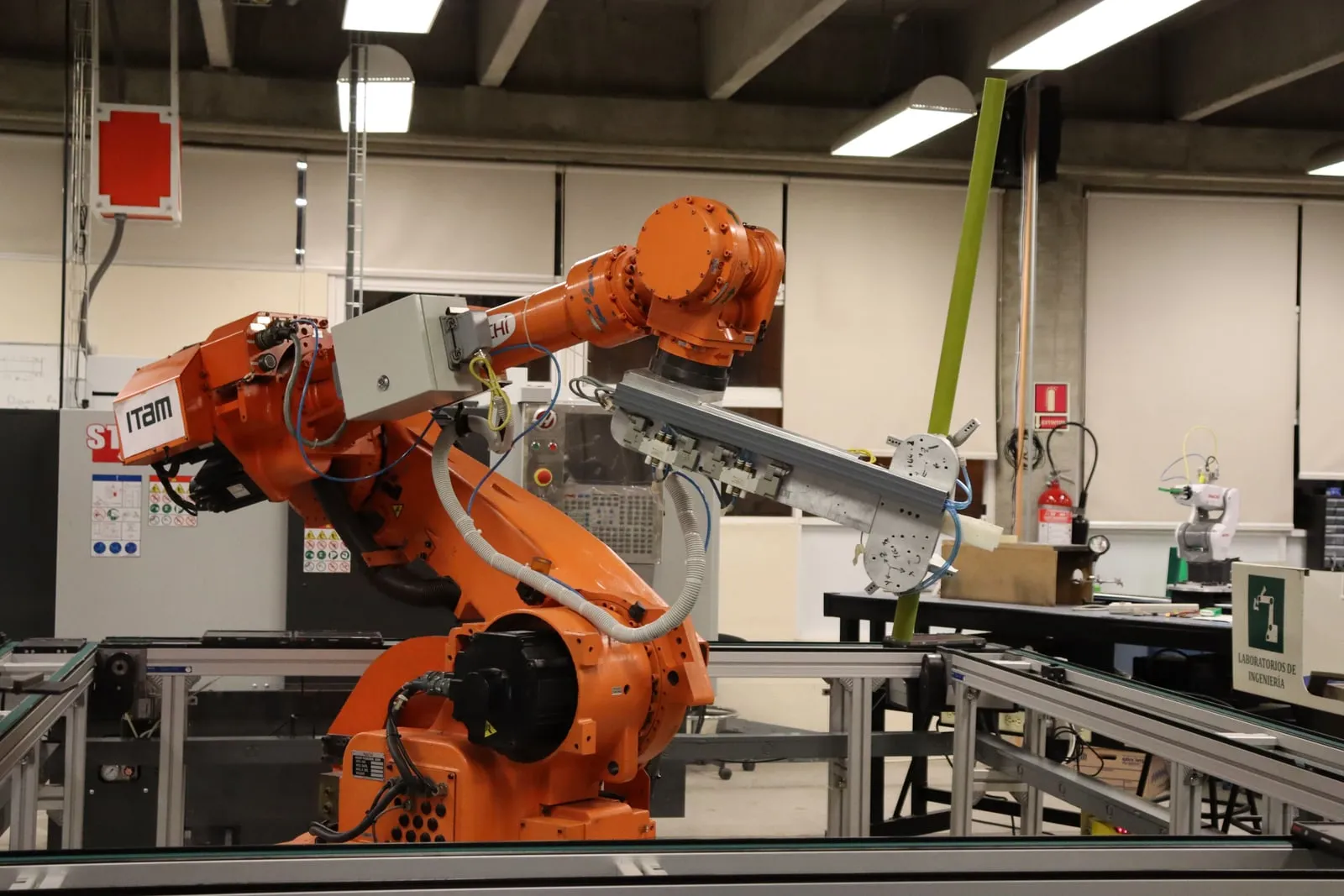 A robotic arm on a workbench in a research laboratory.