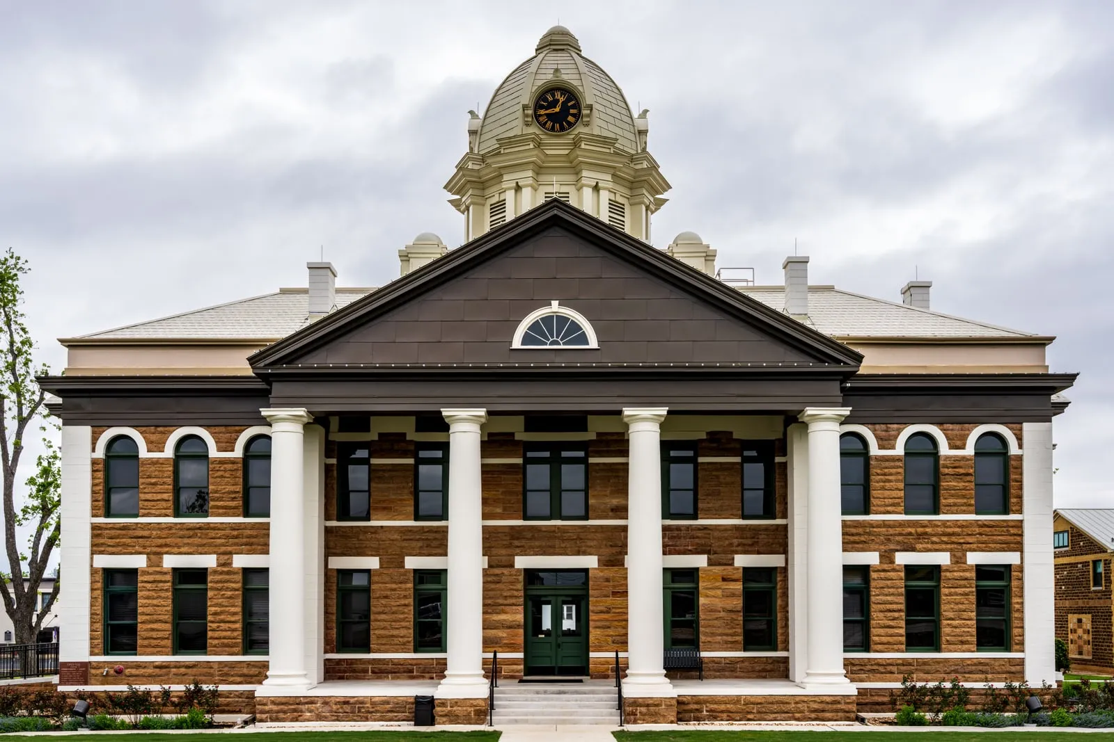 The exterior of a courthouse with stone columns