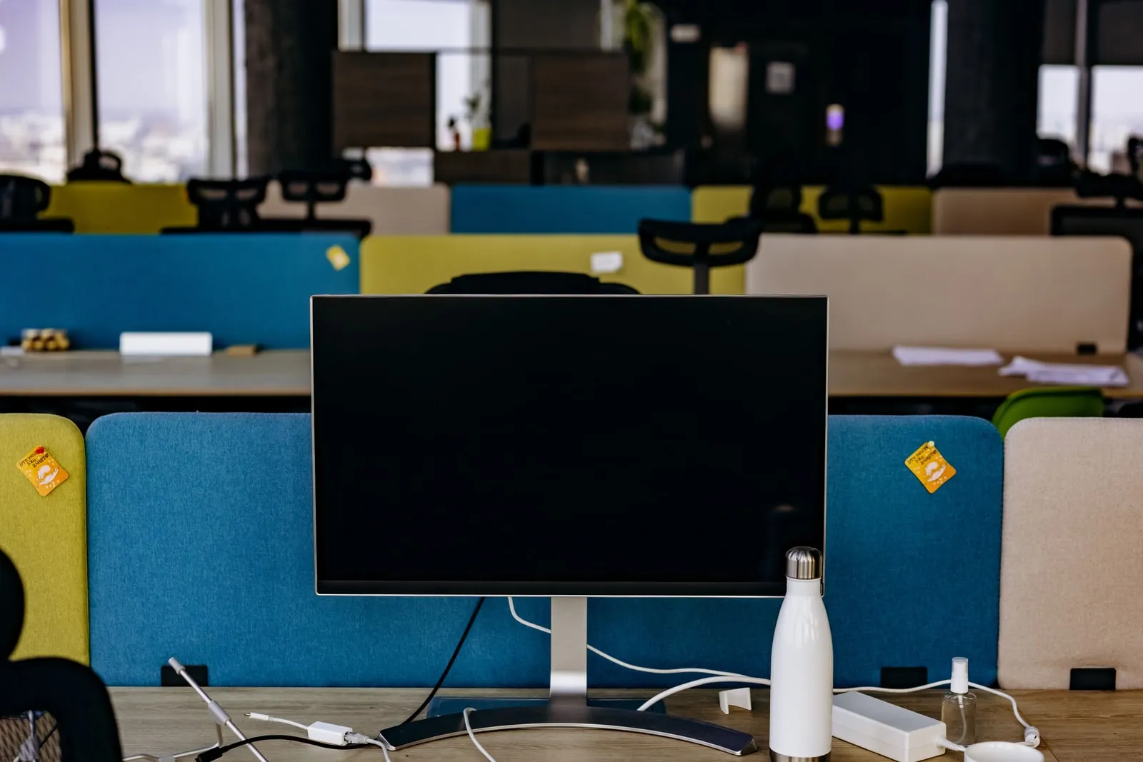 Rows of computer monitors in an open-plan office