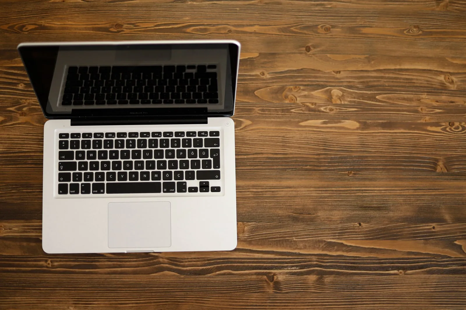 An open laptop computer on a wooden desk