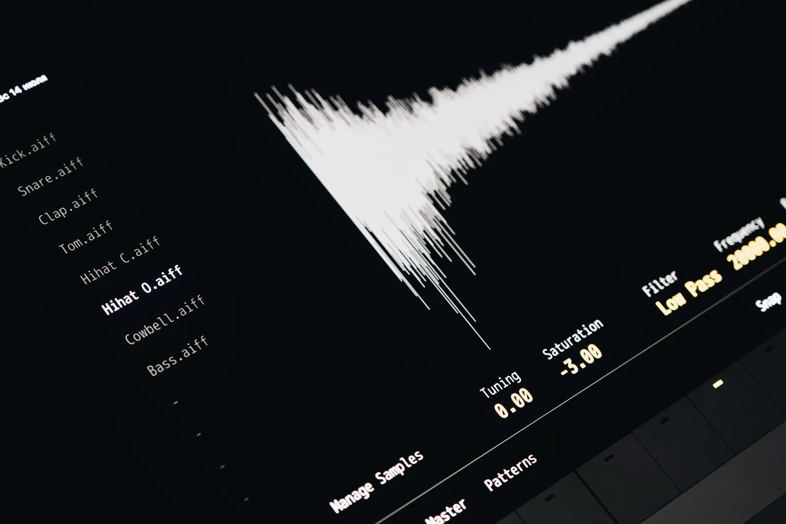 A music production screen showing a waveform above a list of drum samples