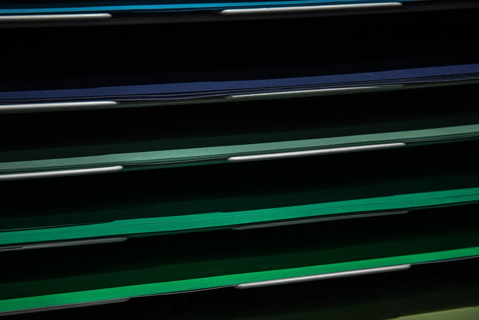Coloured paper file dividers stacked in a rack