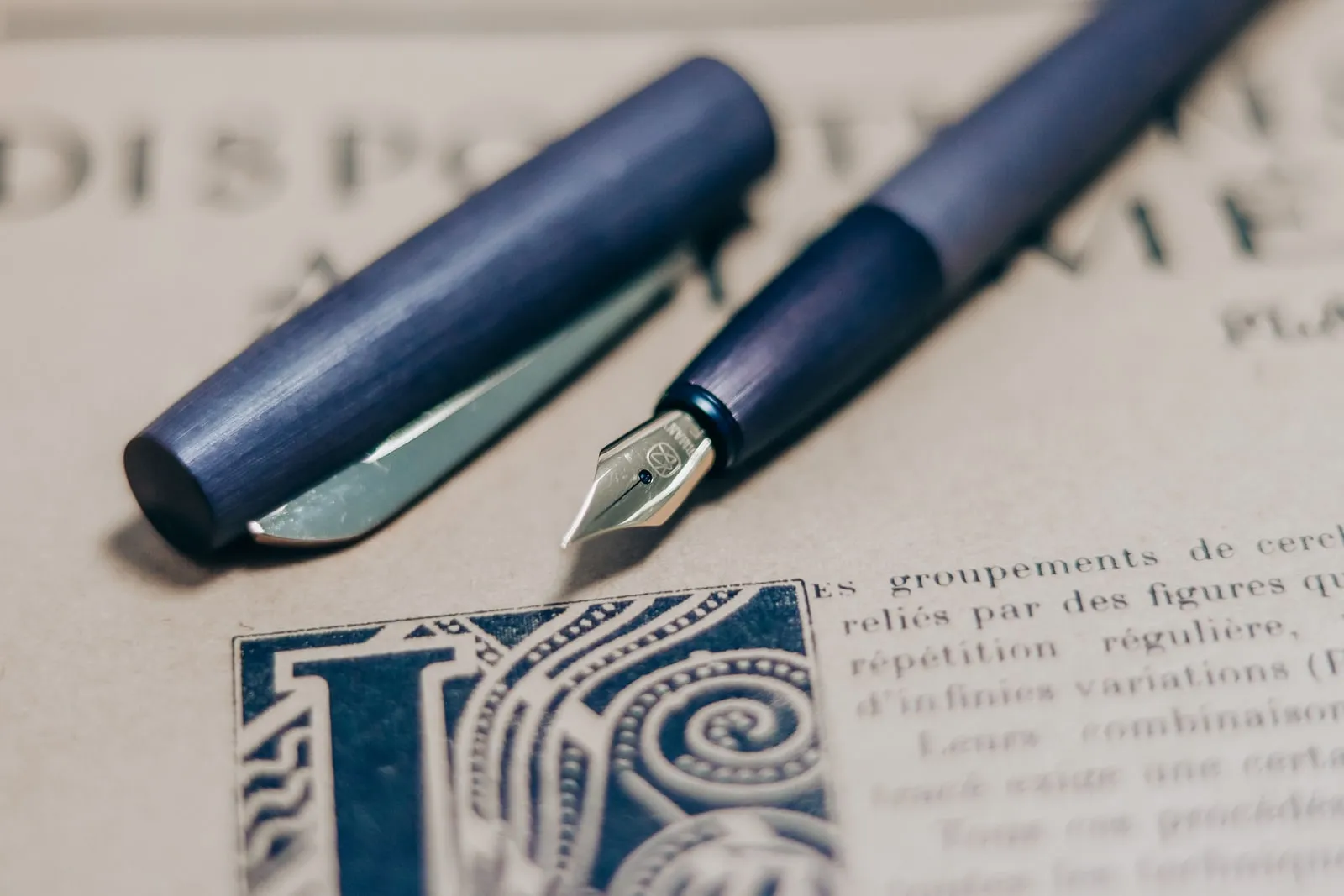 A fountain pen resting on a sheet of printed text