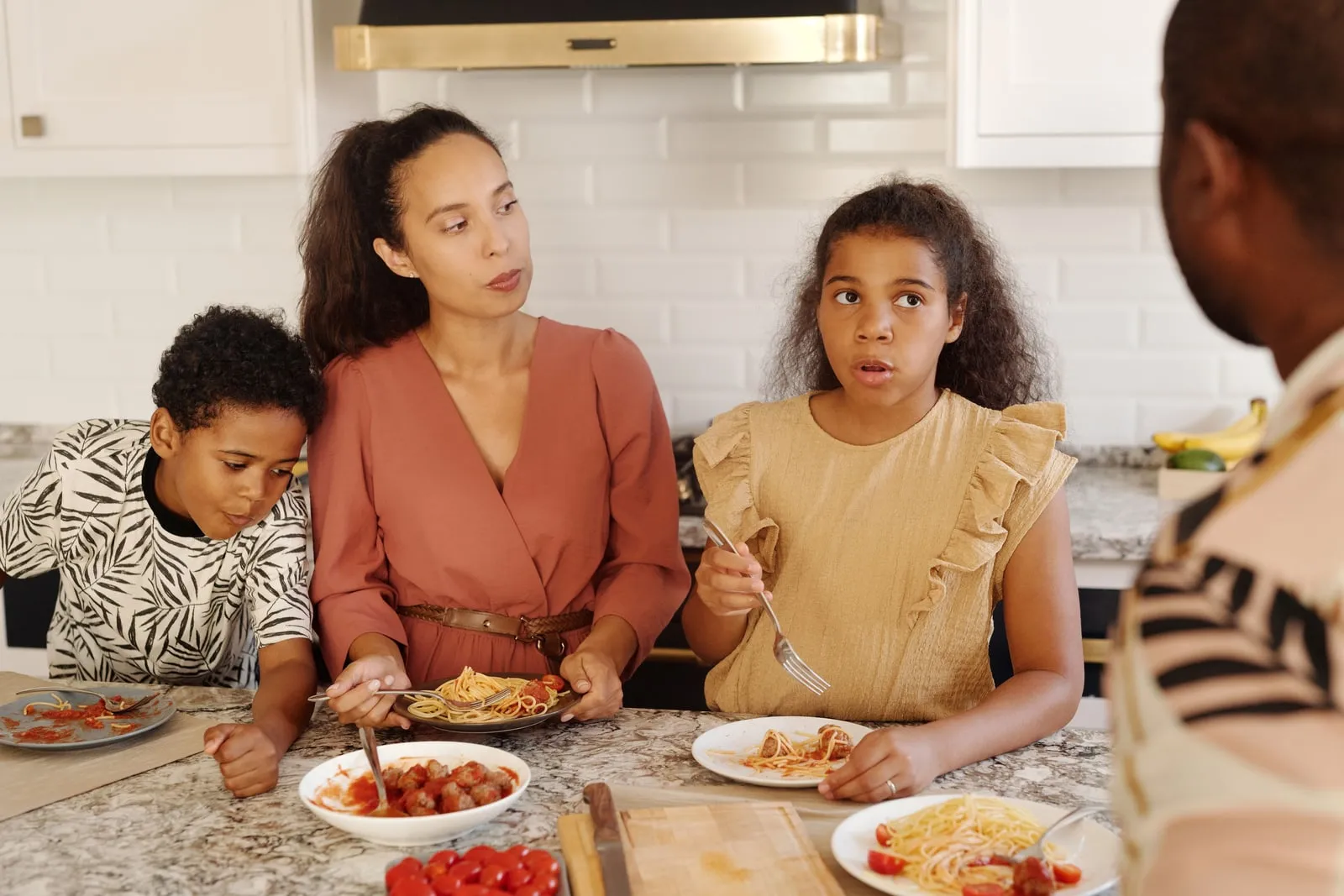 A family eating a meal together in a kitchen