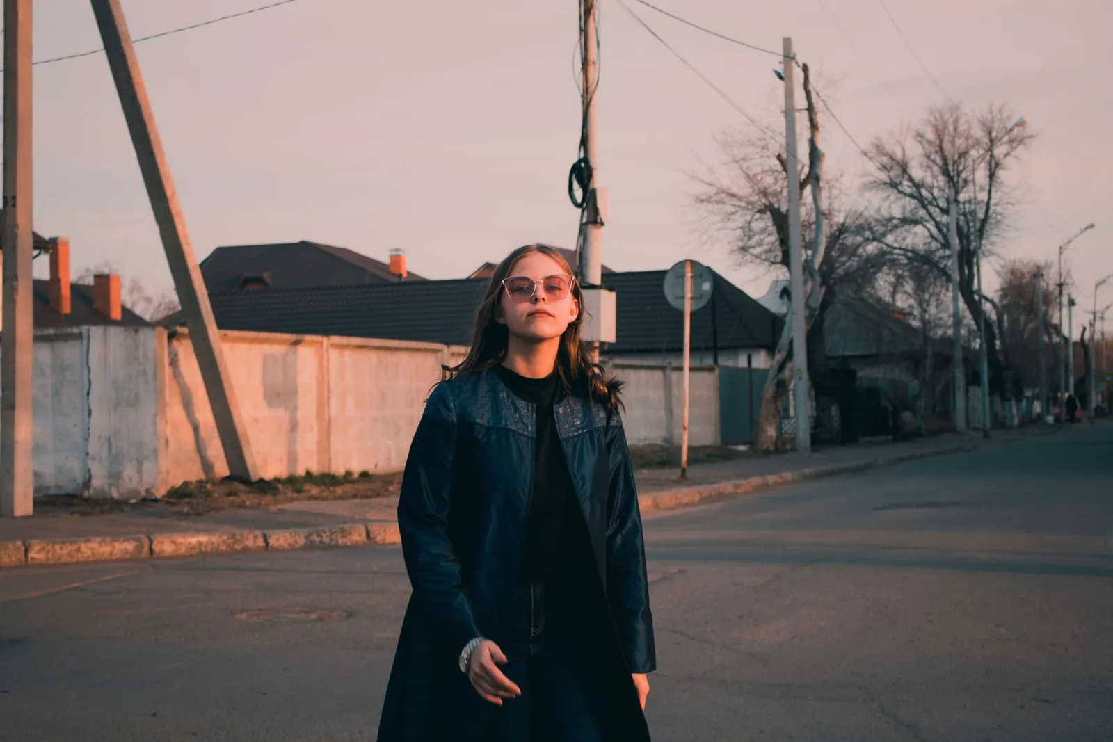 A person wearing sunglasses walking on a city street