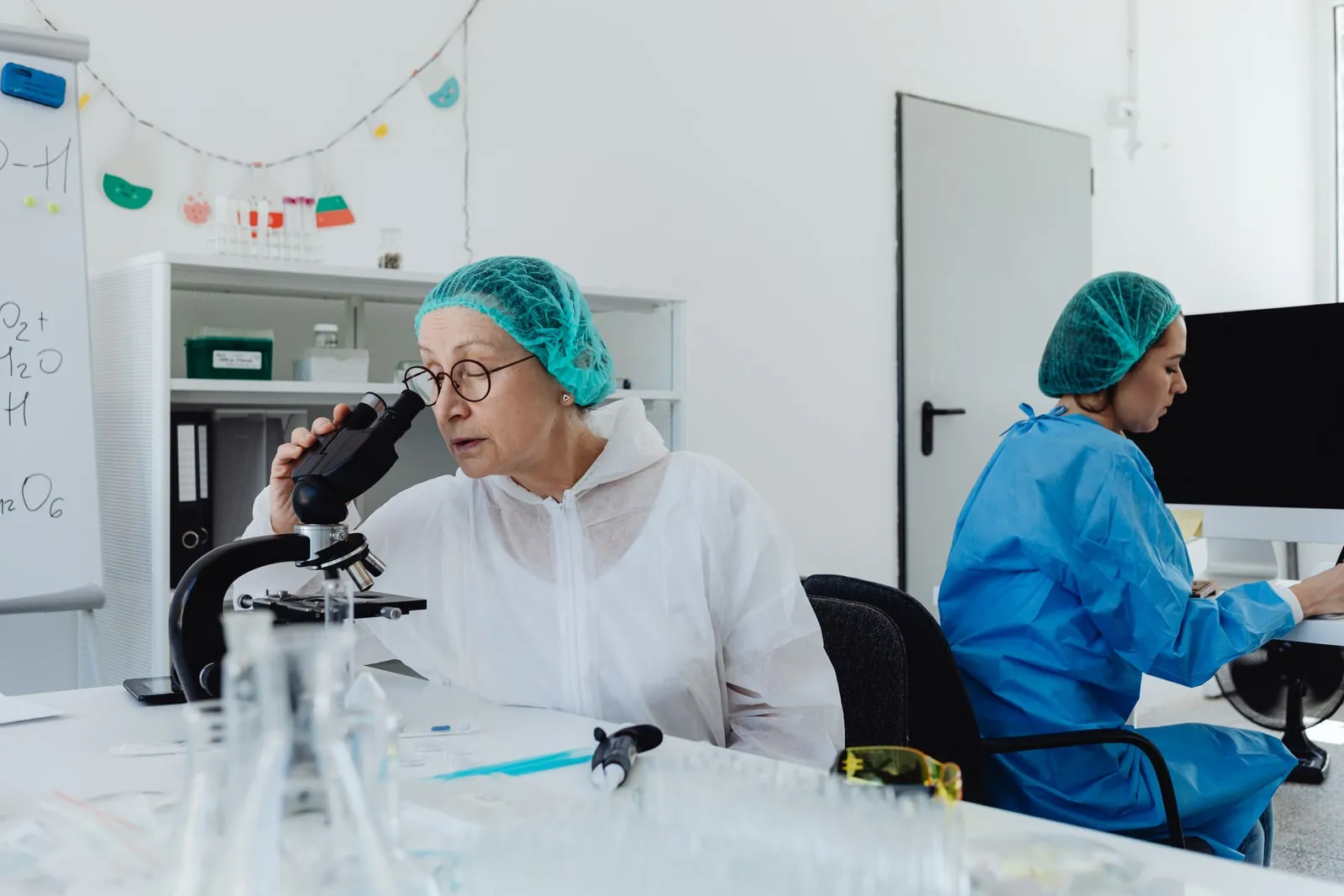 A researcher looking through a microscope in a laboratory