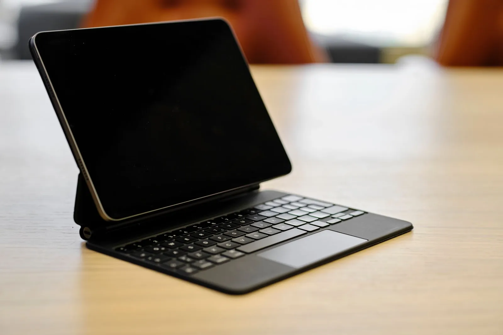 A tablet with a keyboard case on a desk