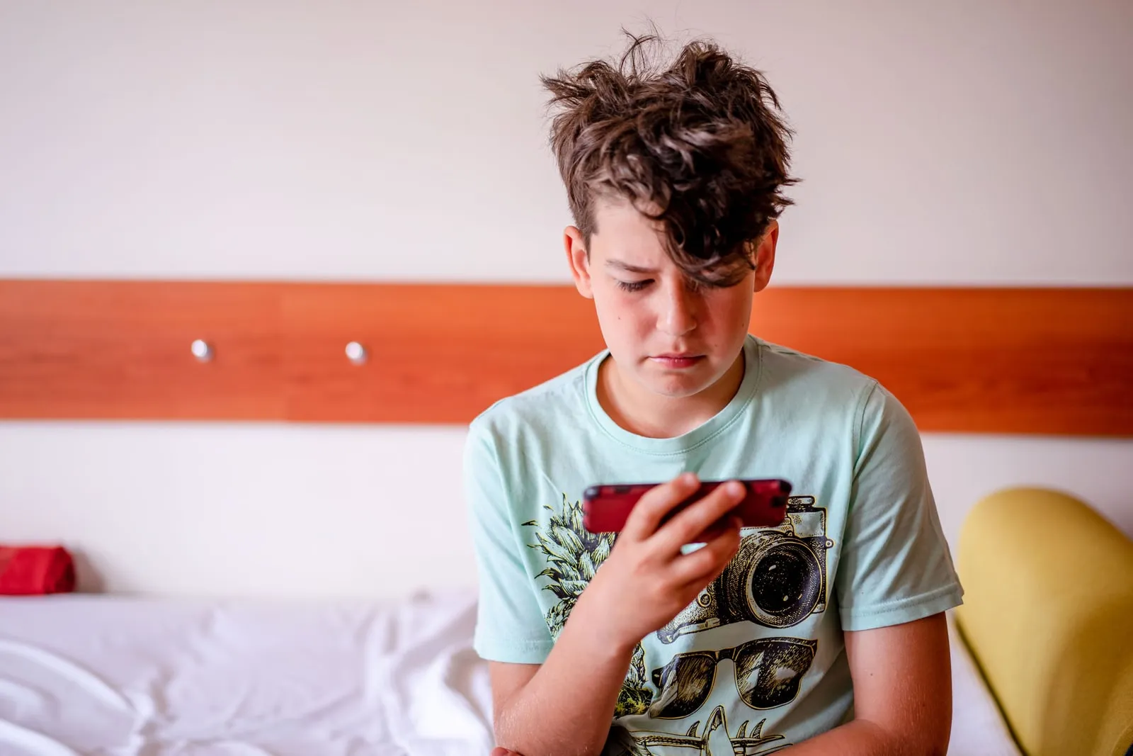A teenager looking at a smartphone