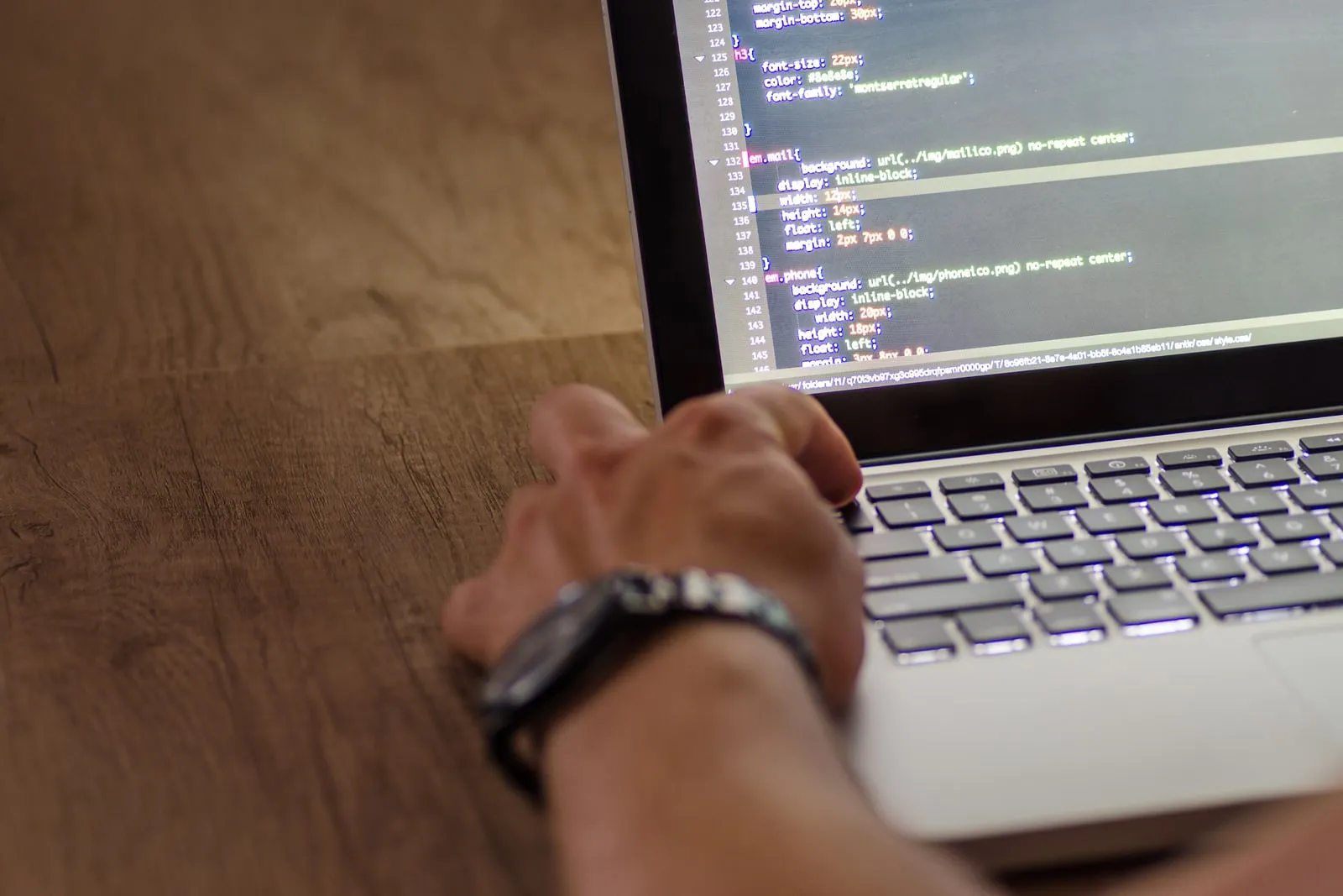 A close-up of a keyboard and screen showing a code editor.