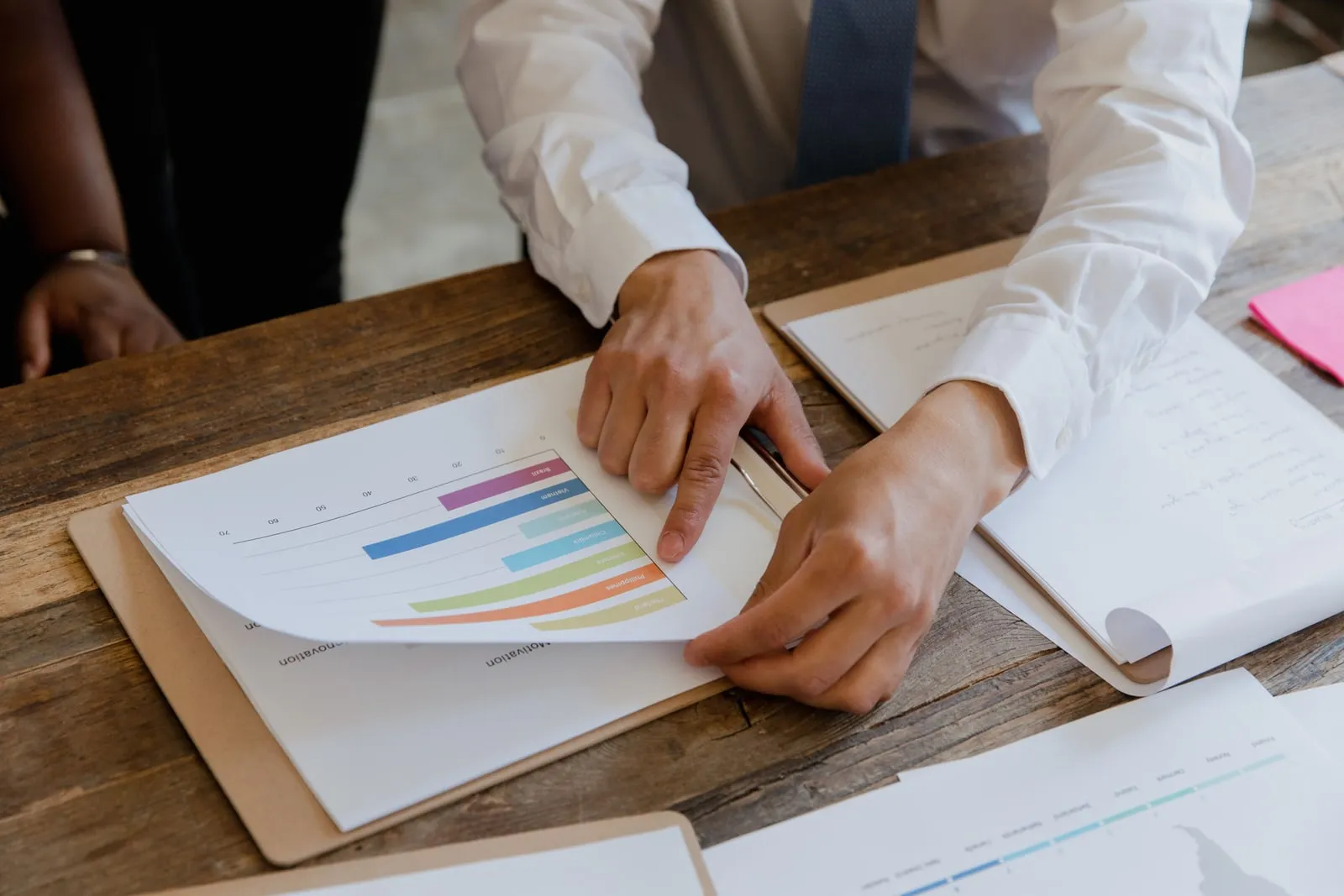 An auditor reviewing printed spreadsheets at a desk