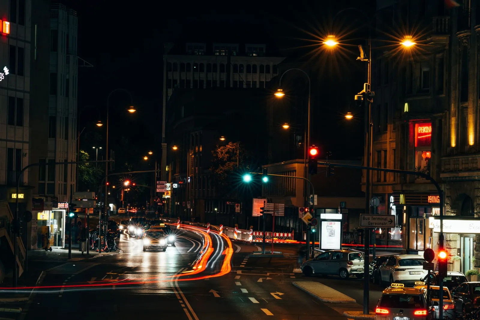 Traffic flowing through a city intersection at night