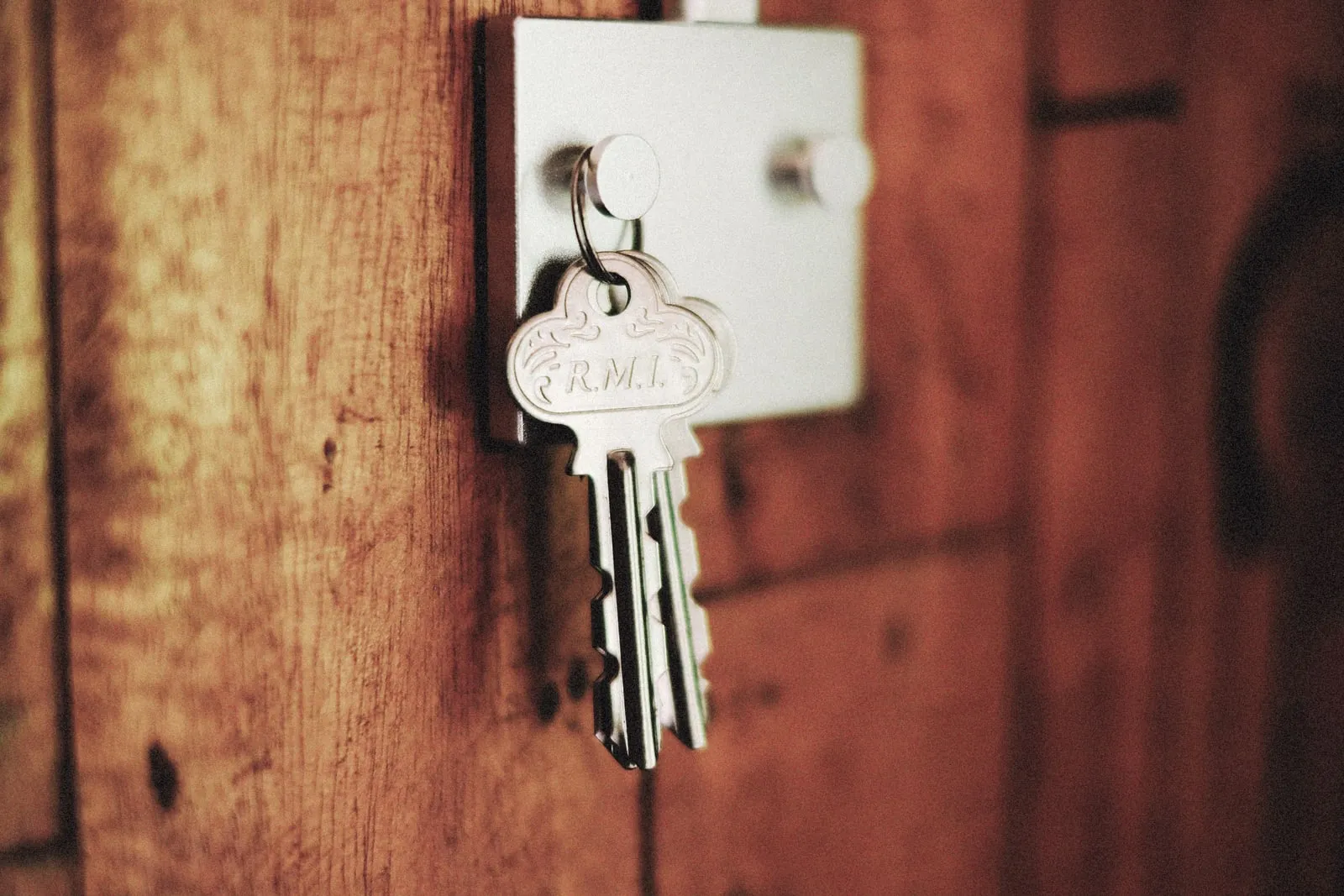 A key left in the lock of a wooden door