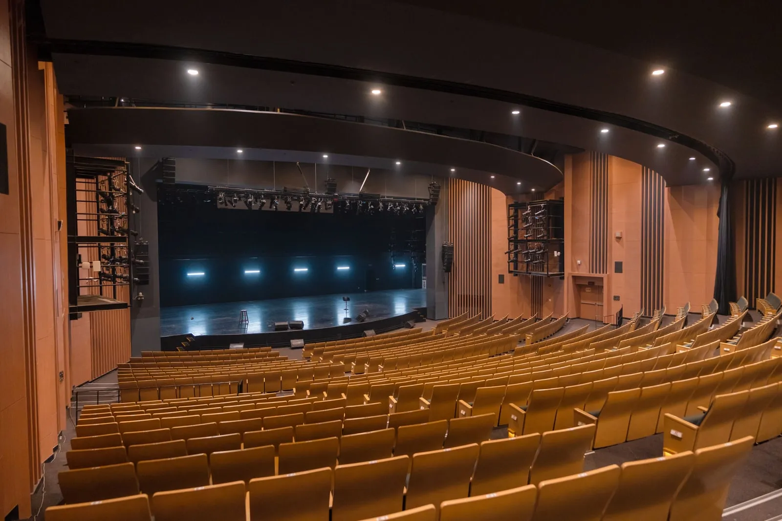 An empty auditorium with a stage and rows of seats