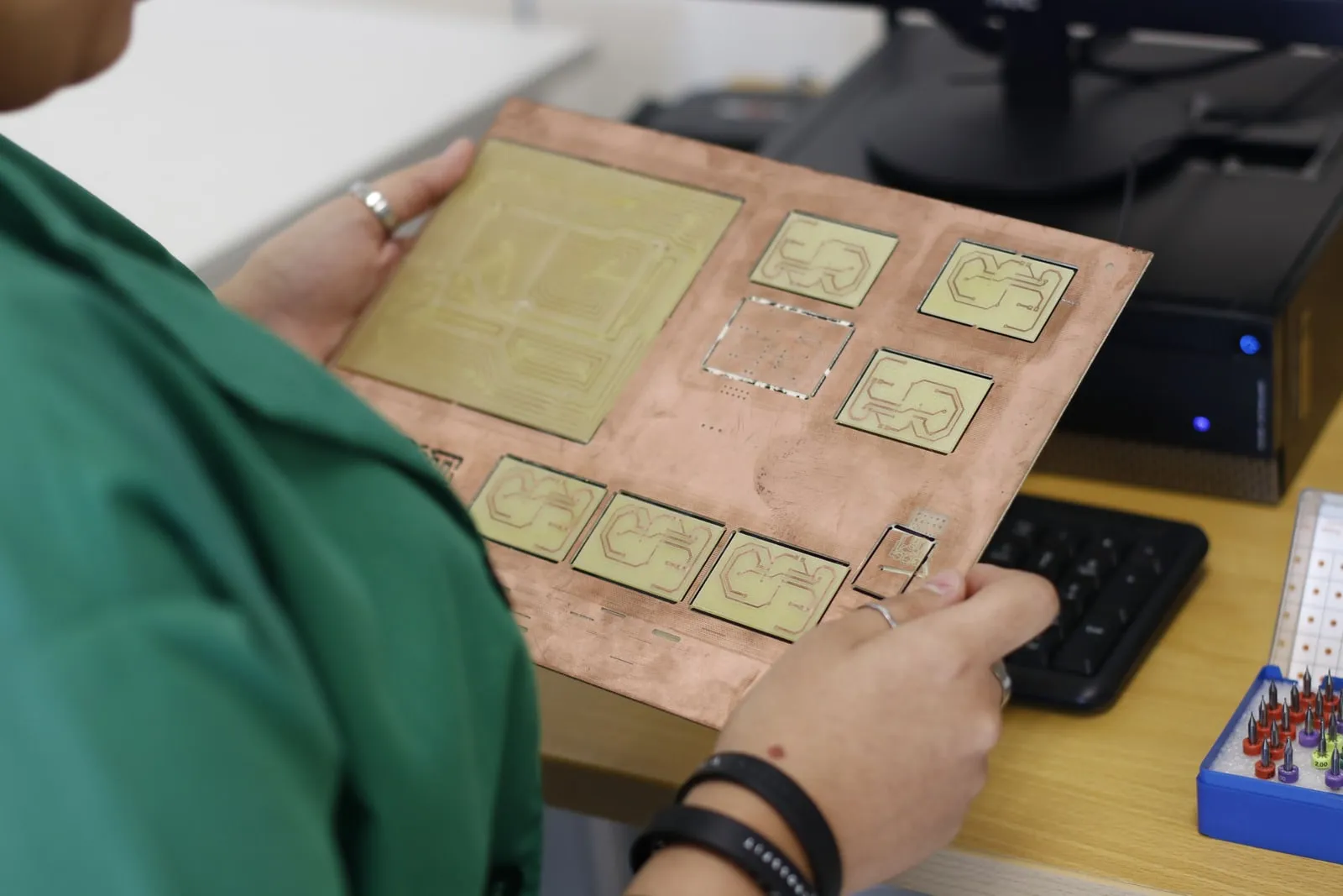 An engineer inspecting electronics in a laboratory
