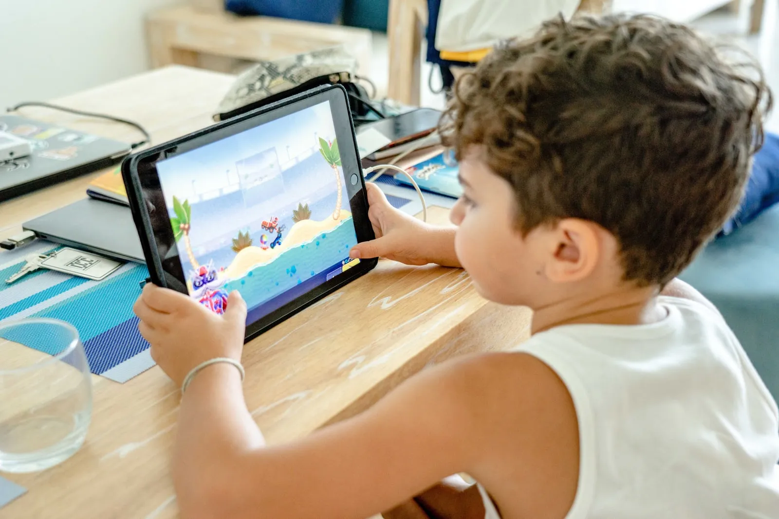 A child using a tablet at a table