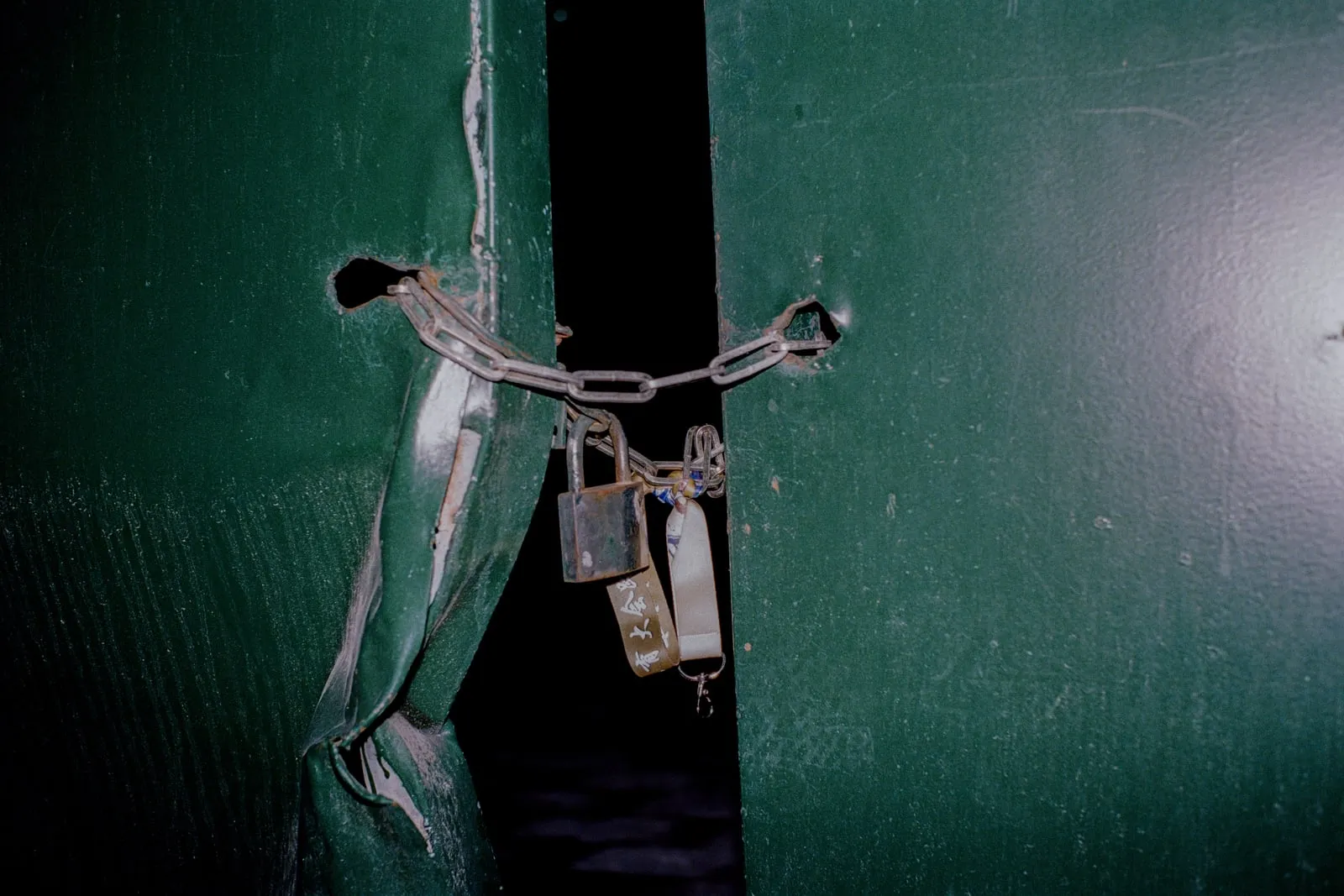 Close-up of a padlock on a metal door